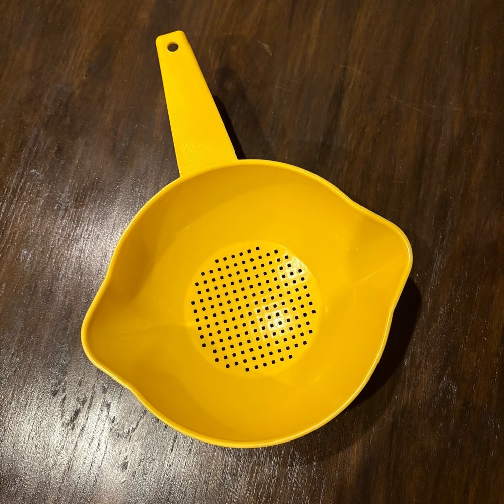 Vintage small yellow Tupperware strainer